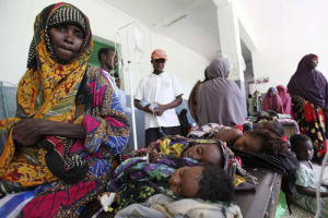 Geediyo Mohamed Abdi, a displaced Somali mother, sits next her children in Banadir hospital in Mogadishu August 14, 2011. Somalia has called for the creation of a special humanitarian force to protect food aid convoys and feeding camps in the famine-hit Horn of Africa country and secure the capital. <br/>Reuters/Feisal Omar