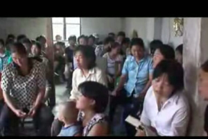 In this still-shot of a video released by the Chinese Christianity Family Federation, a house church in Beijing prays for the 2008 Summer Olympics in Beijing. U.S. and mainland China Christians prayed together for the persecuted church in China, a year before the Olympics. <br/>(Video, Courtesy of China Aid Association)