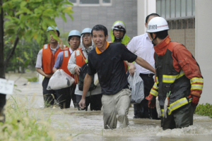 Residents walk in a flooded street to evacuate in Nagoya, central Japan, in this photo taken by Kyodo September 20, 2011. More than a million people in the central Japan city of Nagoya were advised to evacuate on Tuesday as typhoon Roke approached the country, bringing heavy rain. <br/>Residents walk in a flooded street to evacuate in Nagoya, central Japan, in this photo taken by Kyod