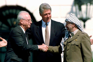 Former U.S. President Bill Clinton (top, C) with former Israeli Prime Minister Yitzhak Rabin (top, L) and Palestine Liberation Organization (PLO) leader Yasser Arafat (top, R) after the signing of the Israeli-PLO peace accord at the White House on September 13, 1993. <br/>Reuters
