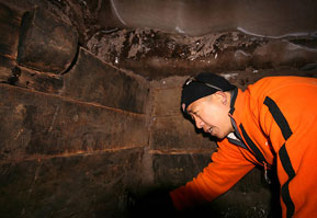An explorer looks at wooden beams inside a compartment of a structure that his team claims might prove the existence of Noah's Ark, on Mount Ararat <br/>NAMI / AFP / Getty Images
