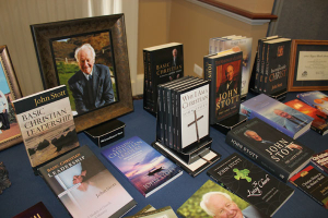 John Stott's books and framed photos are on display at the reception following the U.S. memorial service at College Church in Wheaton, Illinois, on Friday, November 11, 2011. <br/>The Christian Post
