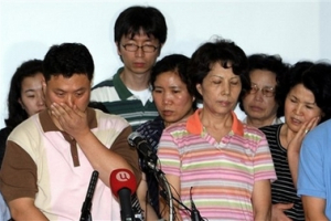 Kim Kyung-sik, left, an elder brother of South Korean Kim Kyung-ja who is one of two women released by Taliban, and other relatives of the South Koreans kidnapped in Afghanistan react in Sunam, South Korea, Monday, Aug. 13, 2007. Two women among the 23 South Koreans kidnapped by the Taliban in mid-July were freed Monday on a rural Afghan roadside and then driven to a U.S. base, the first significant breakthrough in a hostage drama now more than three weeks old. <br/>(AP Photo/ Korea Pool) 