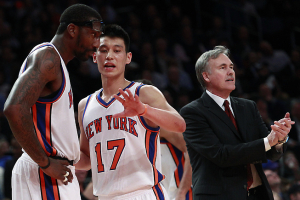 New York Knicks' Jeremy Lin (17) talks to teammate Amare Stoudemire (1) as head coach Mike D'Antoni calls out to the team during the first half of an NBA basketball game against the Sacramento Kings, Wednesday, Feb. 15, 2012, in New York. <br/>AP Photo/Frank Franklin II