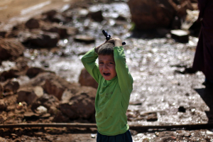 A Syrian boy who fled with his family from the violence in their village, cries as he waits to fill water at a displaced camp, in the Syrian village of Atma, near the Turkish border with Syria, Monday, Nov. 5, 2012. <br/>(AP Photo/ Khalil Hamra)