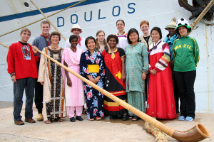 Crewmembers, dressed in clothing representing their nationality, pose for this undated photo alongside the floating charity vessel, MV Doulos. The ship will make its last visit to Hong Kong, Sept. 11 thru Oct. 7, before its scheduled retirement in 2010. <br/>Photo: Operation Mobilization (Hong Kong)