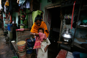 A rehabilitated sex worker cleans her son in front of her one room house in the red light district of Kalighat in Kolkata January 4, 2008. Authorities in eastern India battling to curb human trafficking have now turned to sex workers for help as they step up their drive against the well organised, yet illicit trade. At least 550 minor girls and women forced into the trade have been rescued and rehabilitated by a special committee comprising prostitutes and the government. Read more at http://global.christianpost.com/news/human-trafficking-awareness-day-advocates-urge-world-leaders-to-action-88123/#67ZM04FQMDeOJHPw.99 <br/>Reuters/Parth Sanyal