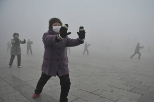 People wear masks to protect themselves during a Tai Chi class on Jan. 14 in Fuyang City, China. Severe air pollution forced factories to cut back on emissions and kept children indoors while hospitals reported a rise in respiratory cases. <br/>AP