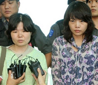 South Korean Kim Gina, right, and Kim Kyung-ja, left, released South Korean hostages in Afghanistan answer reporters questions upon their arrival at Incheon International Airport in Incheon, west of Seoul, South Korea, Friday, Aug. 17, 2007. Two South Korean hostages freed from Taliban captivity arrived home Friday, amid an ongoing standoff where 19 of their compatriots remain held by the insurgent group in Afghanistan. <br/>(Photo: Yonhap / Hwang Kwang-mo)