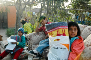 A girl hold a bag containing a blanket in this undated photo released by World Vision after an 8.0 earthquake devastated central Peru, Wednesday. Aug.15, 2007 <br/>Photo: World Vision 