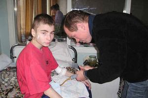 A Father’s House missionary gives medical help to a needy child. <br/>Intercede International 
