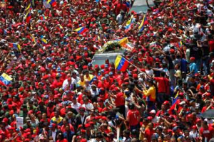 Hugo Chávez's coffin is driven through Caracas to the Fuerte Tiuna military academy, where his body will lie in state. <br/>Jorge Dan Lopez/Reuters