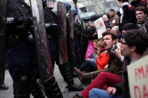 Protestors face riot police officers, during an anti gay marriage demonstration, in Paris, Sunday, March 24, 2013. Thousands of French conservatives, families and activists have converged on the capital to try to stop the country from allowing same-sex couples to marry and adopt children. The lower house of France's parliament approved the <br/>Thibault Camus