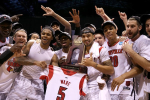 Louisville players hold up their NCAA Midwest Regional trophy along with the jersey of injured teammate Kevin Ware in Indianapolis on Sunday. <br/>Andy Lyons / Getty Images / March 31, 2013
