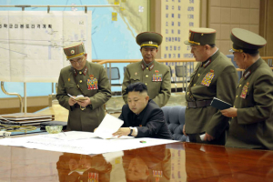 North Korean leader Kim Jong-un presides over an urgent operation meeting on the Korean People's Army Strategic Rocket Force's performance of duty for firepower strike at the Supreme Command in Pyongyang, March 29, 2013. The sign on the left reads, ''Strategic force's plan to hit the mainland of the U.S.'' <br/>Reuters/KCNA