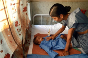 An unidentified toddler who survived the building collapse recovers at a hospital in Thane. <br/>(AFP: Punit Paranjpe)