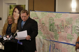 Larry Pott, father of Audrie Pott, who committed suicide after she was sexually assaulted, reads a statement at a news conference in San Jose. Audrie's mother, Sheila Pott, is at left. <br/>Eric Risberg / Associated Press / April 15, 2013