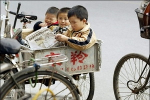 File photo shows three children sitting in the back of a tricycle on a street in Beijing. China has come under fire, Monday, after a BBC report revealed that China has too many senior-citizens, but too little young people as a result of its current one-child policy. <br/>(AFP/File/Peter Parks) 