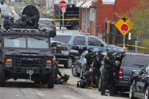 Police officers take position during a search for the Boston Marathon bombing suspects in Watertown, Massachusetts April 19, 2013. <br/> REUTERS/Brian Snyder