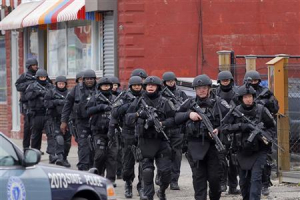 SWAT teams enter a suburban neighborhood to search an apartment for the remaining suspect in the Boston Marathon bombings in Watertown, Massachusetts April 19, 2013. <br/>REUTERS/Jessica Rinaldi