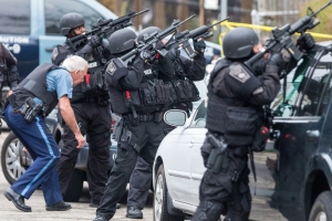 SWAT teams moved into position at the intersection of Nichols Avenue and Melendy Avenue in Watertown while searching for one of the two suspects. <br/>Aram Boghosian/Boston Globe via Getty Images