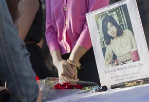 A photo of Lu Lingzi, the third fatality of the Boston Marathon bombings, is seen outside the Marsh Chapel before a memorial in Boston on April 17, 2013. <br/>Reuters