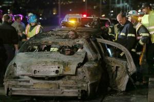San Mateo County firefighters and California Highway Patrol personnel investigate the scene of a limousine fire on the westbound side of the San Mateo-Hayward Bridge in Foster City, Calif., on Saturday, May 4, 2013. Five people died when they were trapped in the limo that caught fire as they were traveling, and four others and the driver were able to escape, according to the Oakland Tribune-Bay Area News Group. <br/>Oakland Tribune-Bay Area News Group, Jane Tyska