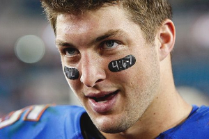 Updated photo shows Tim Tebow with Bible verse written on his eye black. <br/>Scrapetv.com