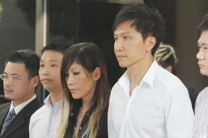 Kong Hee (second left), founding pastor of City Harvest Church, holding hands with wife Ho Yeow Sun (third left) as they leave the subordinate courts in Singapore. <br/>