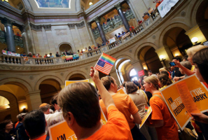 Hundreds of people gathered in the Minnesota Capitol on Monday, singing, waving signs and shouting loud enough to be heard inside the Senate chamber as the debate went on before the vote on same-sex marriage. <br/>Jim Mone/Associated Press