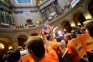 Hundreds of people gathered in the Minnesota Capitol on Monday, singing, waving signs and shouting loud enough to be heard inside the Senate chamber as the debate went on before the vote on same-sex marriage. <br/>Jim Mone/Associated Press