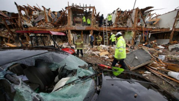 On April 17, the fire caused large quantities of ammonium nitrate to explode in two blasts that were felt from miles away. Fifteen people died as a result of the explosions, most of which were first responders to the catastrophe. Numerous houses were damaged, as well as two of the city’s schools. <br/>Eric Gay/AP Photo