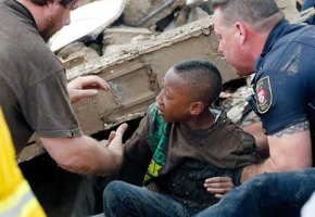 A boy is pulled out from the rubble caused by the tornado that ripped through the city of Moore, Oklahoma. <br/>