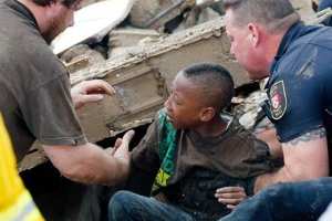 A boy is pulled out from the rubble caused by the tornado that ripped through the city of Moore, Oklahoma. <br/>