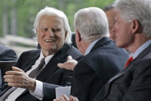 Billy Graham, left, reaches out to former President Jimmy Carter as Bill Clinton, far right looks on during the dedication for the Billy Graham Library in Charlotte, N.C., Thursday, May 31, 2007. <br/>