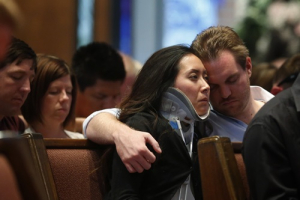 Plaza Towers elementary school teacher Jennifer Doan (L) and her fiance Nyle Rogers listen to speakers at the First Baptist Church of Moore during a community memorial service following the large tornado in Moore, Oklahoma May 26, 2013. <br/>REUTERS/Sue Ogrocki/Pool 