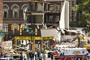 Rescue workers search through rubble following a building collapse in Philadelphia June 5, 2013. A building collapsed in downtown Philadelphia on Wednesday and rescue workers pulled 12 people from the rubble and were trying to reach two others trapped beneath it, fire officials said. <br/>REUTERS/Eduardo Munoz