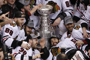 Chicago Blackhawks' Patrick Kane (L), Dave Bolland (C) and goalie Corey Crawford (R) celebrate with the Stanley Cup after they defeated the Boston Bruins in Game 6 of their NHL Stanley Cup Finals hockey series in Boston, Massachusetts, June 24, 2013. <br/>REUTERS/Adam Hunger