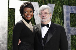 Director George Lucas and his partner Mellody Hobson arrive at the 2012 Vanity Fair Oscar party in West Hollywood, California February 26, 2012. <br/>Reuters/Danny Moloshok