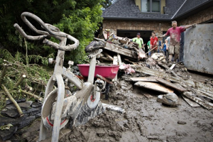 A mud-covered exercise bike sits outside a home as residents clean up after floods in Calgary, Alberta June 25, 2013. Canada's oil capital, Calgary, started the slow process of cleaning up its downtown on Tuesday in the aftermath of record-breaking floods, with many business owners returning for the first time to properties they were forced to leave last week. <br/>REUTERS/Andy Clark