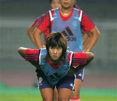 China's Han Duan stretches during a practice session for the 2007 FIFA Women's World Cup in Wuhan, in China's central Hubei province Tuesday Sept 11, 2007. China plays their first Group D match against Denmark on Sept. 12. <br/>Photo: AP Images / Greg Baker
