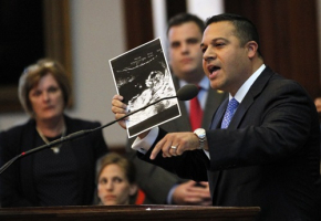 Texas State Representative Jason Villalba holds a sonogram of his thirteen-week-old son taken last week as he offers closing remarks during a meeting of the state legislature to consider legislation restricting abortion rights in Austin, Texas July 9, 2013. The Texas House of Representatives approved the bill on Tuesday that would mandate sweeping abortion restrictions, including a ban on most abortions after 20 weeks of pregnancy and tougher standards for abortion clinics. <br/>REUTERS/Mike Stone 