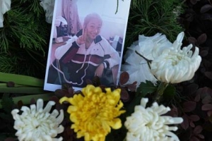 A photograph of 17-year-old Wang Linjia is placed among flowers outside her high school in Jiangshan in China's eastern Zhejiang province on Monday, July 8, 2013. <br/>