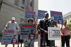 Rev. Anthony Evans, president of the National Black Church Initiative, leads a prayer during a demonstration asking for justice for Trayvon Martin, outside the Department of Justice in Washington July 15, 2013. U.S. President Barack Obama called for calm on Sunday after the acquittal of George Zimmerman in the shooting death of unarmed black teenager Trayvon Martin, as thousands of civil rights demonstrators turned out at rallies to condemn racial profiling. Zimmerman, cleared late on Saturday by a Florida jury of six women, still faces public outrage, a possible civil suit and demands for a federal investigation. <br/>REUTERS/Jose Luis Magana 