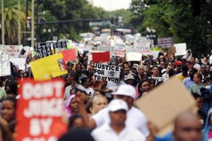 Demonstrators hold a rally in support of slain teenager Trayvon Martin in Orlando, Florida July 17, 2013. George Zimmerman, a neighbourhood watch volunteer, was acquitted of second-degree murder and manslaughter in the February 2012 shooting of 17-year-old Martin. <br/>REUTERS/David Manning 