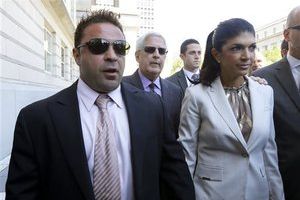Joe Giudice, 43, left, and his wife, Teresa Giudice, 41, walk out of Martin Luther King, Jr. Courthouse after a court appearance, Tuesday, July 30, 2013, in Newark, N.J. <br/>