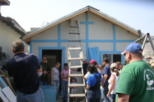 Volunteer homebuilders of Malibu Presbyterian Church offer prayers during construction of a home during their trip on May 19-20 in Baja, Mexico. <br/>