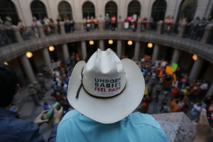 Opponents and supporters of an abortion bill gather in a courtyard outside a hearing for the bill at the state capitol, Tuesday, July 2, 2013, in Austin, Texas. Gov. Rick Perry has called lawmakers back for another special session with abortion on the top of the agenda. <br/> (AP Photo/Eric Gay)
