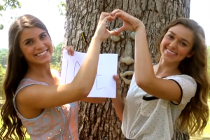 Best friends Sadie Robertson and Kolby Koloff holding a ''Love'' sign together. They talked about sin, forgiveness, and accountability in their first ‘’I am Different’’ devotional video Monday night. <br/>The Gospel Herald via Youtube