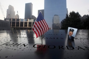 A picture of New York City firefighter James Crawford, one of the thousands of people who died of the attacks of September 11, 2001, is seen at the National September 11 Memorial. The official New York City tribute began at the memorial plaza at the World Trade Center site. (Reuters) <br/>